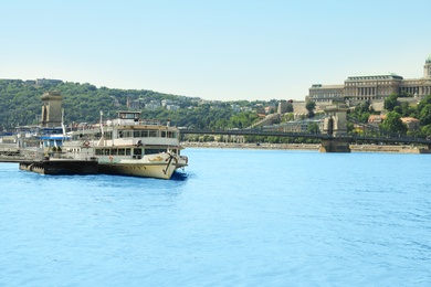 BUDAPEST, HUNGARY - JUNE 18, 2019: Beautiful view with Buda Castle, Szechenyi Chain Bridge and tour boat on Danube river