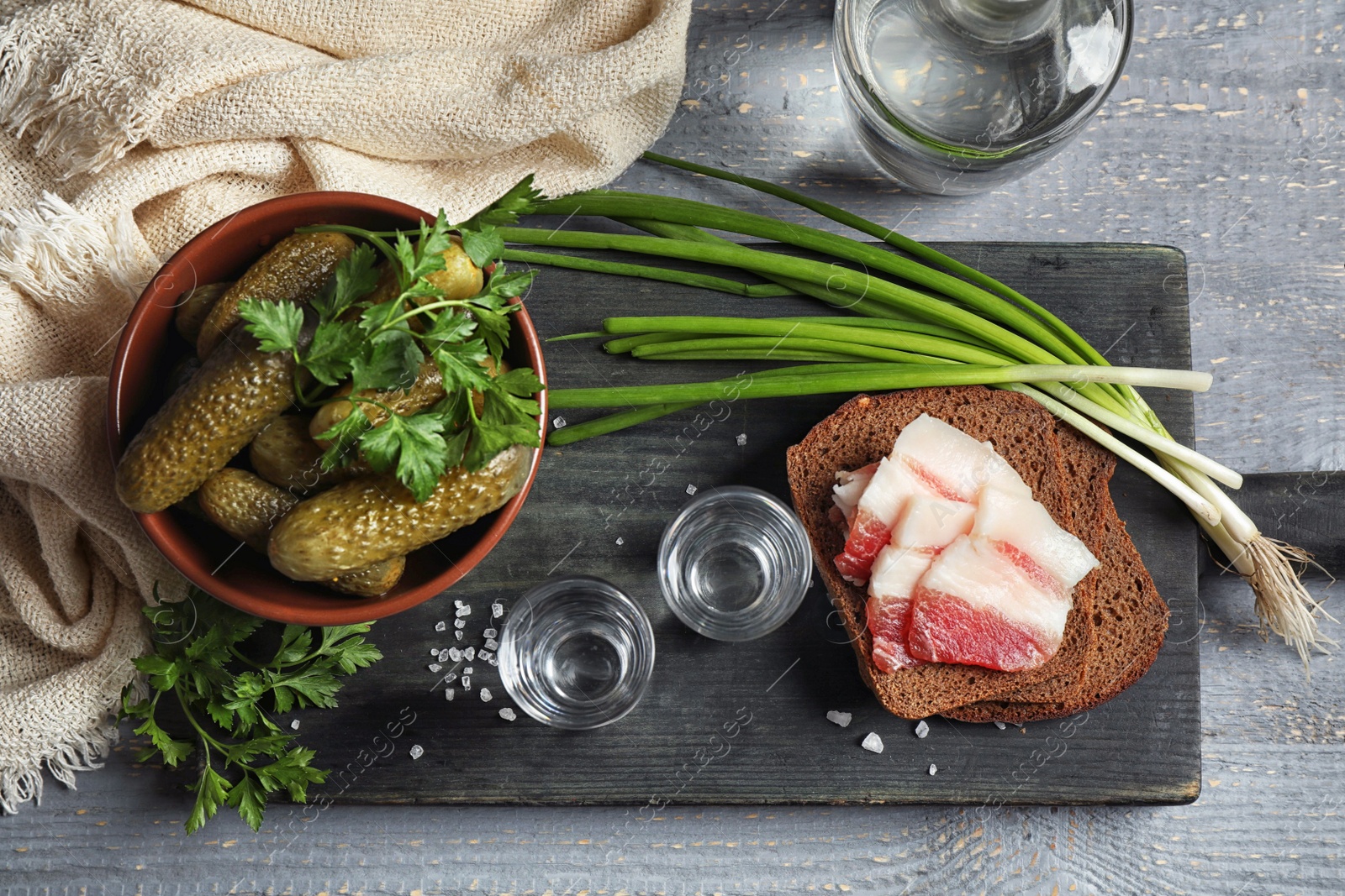 Photo of Flat lay composition with cold Russian vodka on grey wooden table