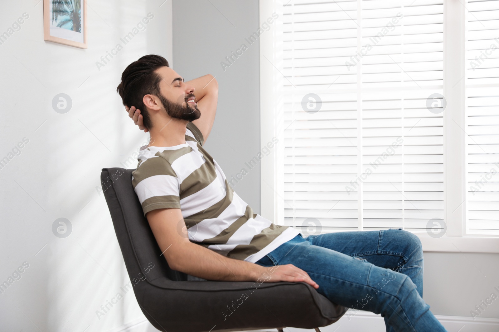 Photo of Young man relaxing at home. Peaceful rest