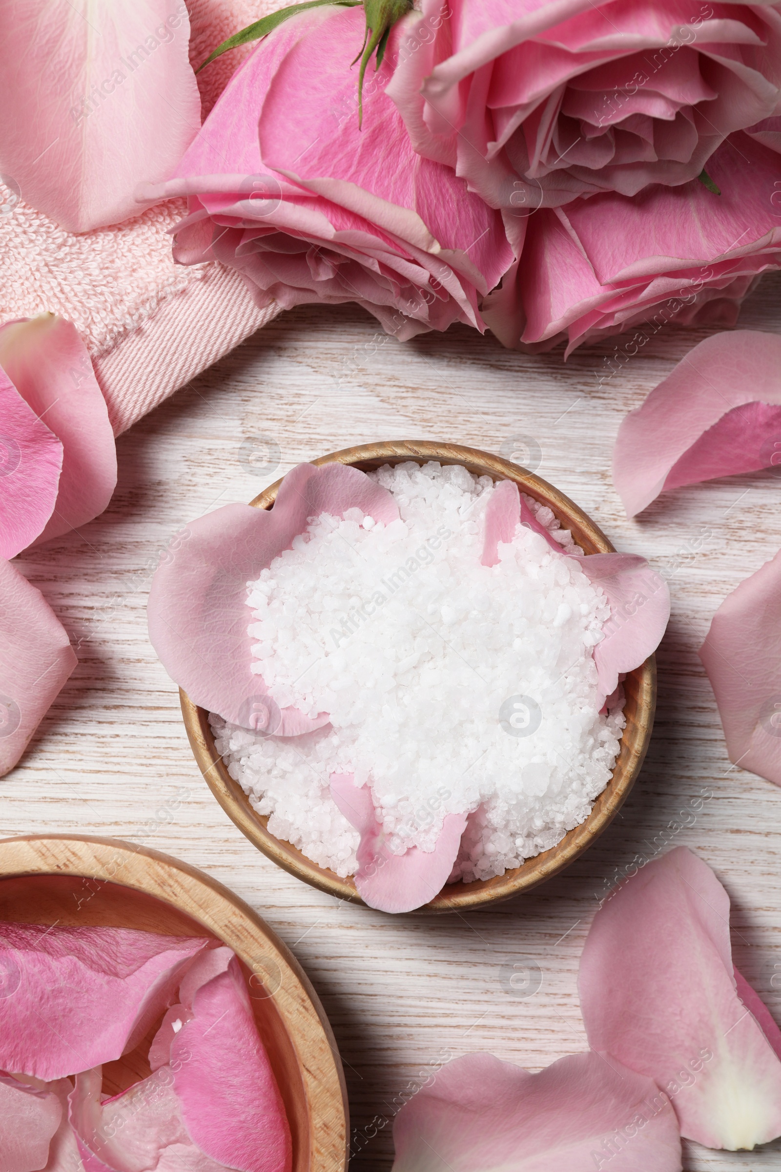 Photo of Flat lay composition with sea salt and beautiful petals of roses on white wooden table