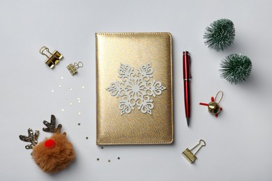 Photo of Stylish planner and Christmas decor on white background, flat lay. New Year aims
