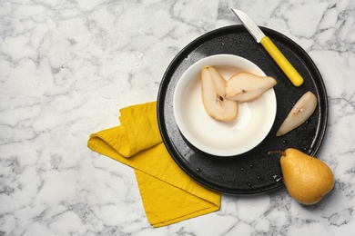 Flat lay composition with ripe pears on marble background. Space for text