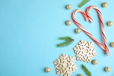 Photo of Flat lay composition with Christmas decor on blue background. Space for text