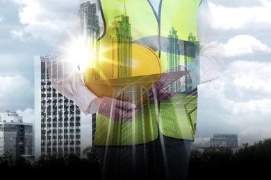 Image of Engineer with hard hat and cityscapes, multiple exposure