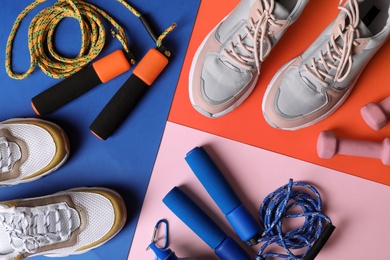 Flat lay composition with fitness gym equipment on color background