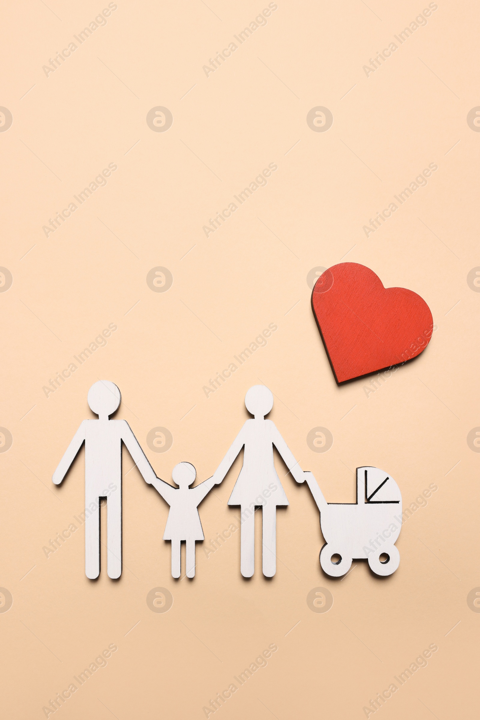 Photo of Figures of family and heart on beige background, top view. Insurance concept