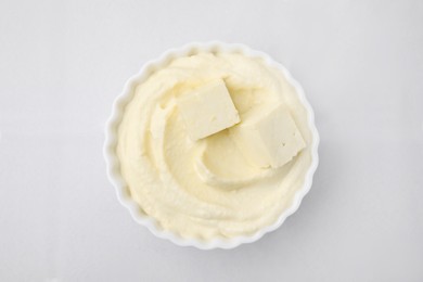 Delicious tofu sauce in bowl on white tiled table, top view