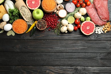 Flat lay composition with fresh meat and other products on wooden table, space for text. Balanced diet