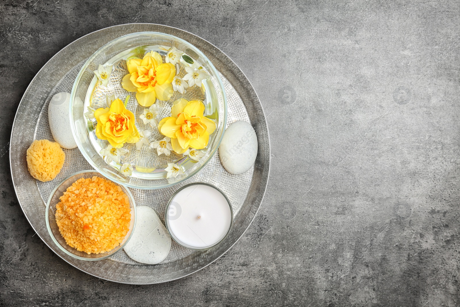 Photo of Composition with spa accessories and flowers on grey background