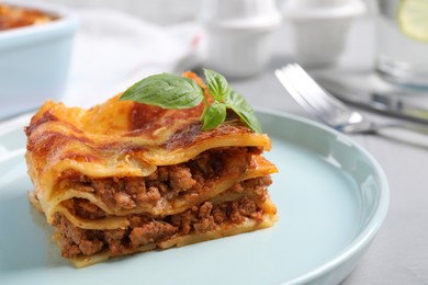 Photo of Tasty cooked lasagna served on grey table, closeup