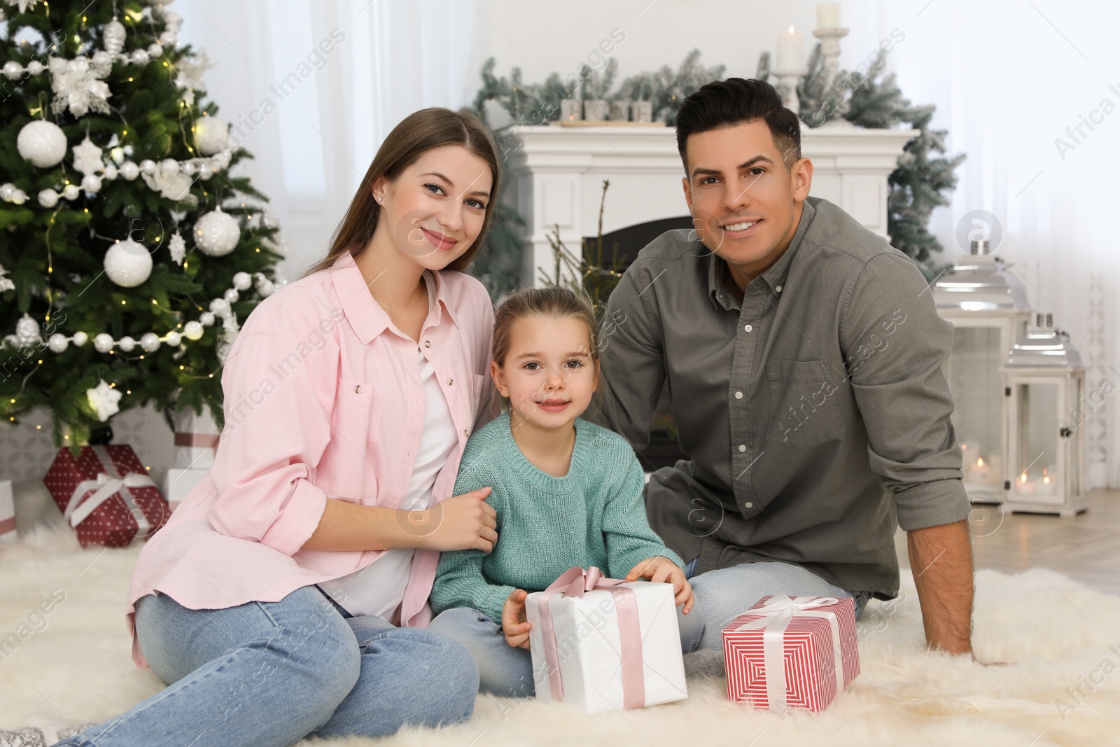 Photo of Happy family in room decorated for Christmas