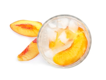 Peach cocktail in glass and fresh fruit on white background, top view