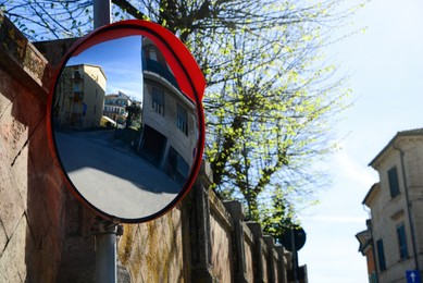 Photo of Traffic mirror on city street, space for text