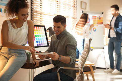 Photo of Team of professional designers working in office