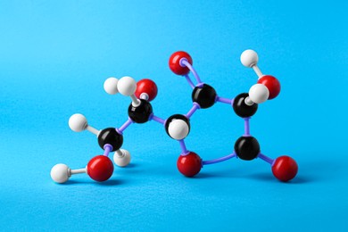 Photo of Molecule of vitamin C on light blue background. Chemical model