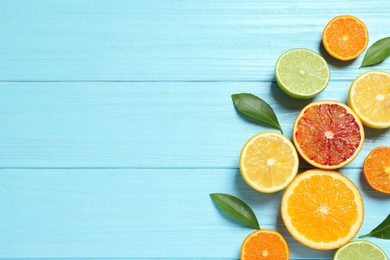 Flat lay composition with different citrus fruits and space for text on wooden background