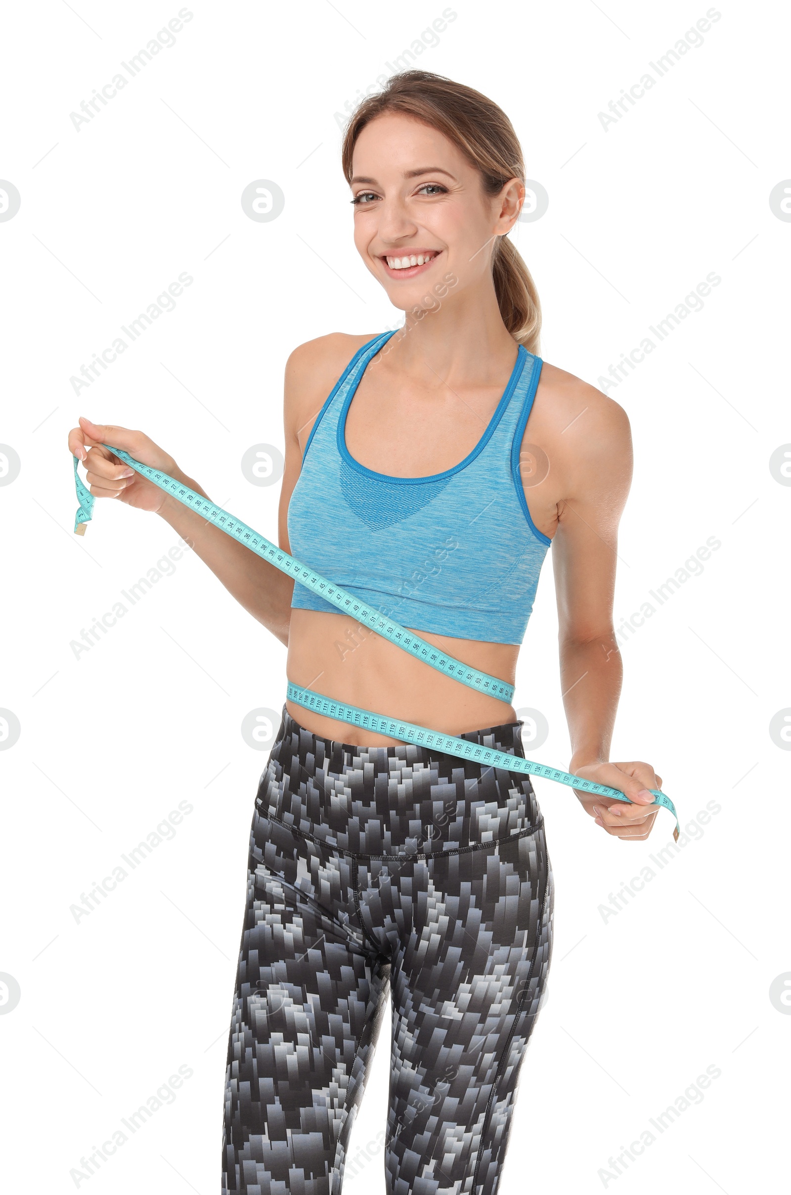 Photo of Happy slim woman in sportswear with measuring tape on white background. Positive weight loss diet results