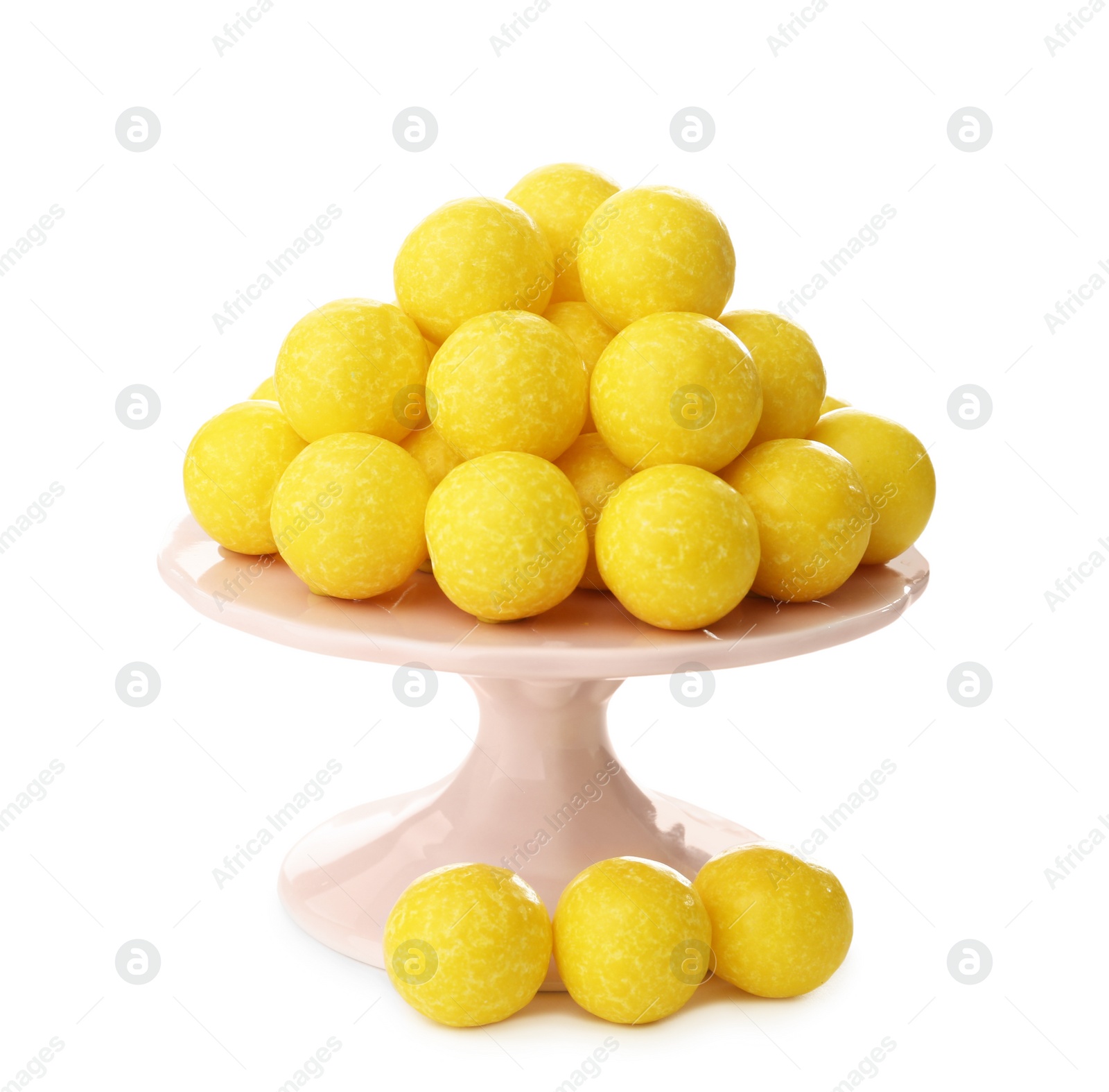 Photo of Tasty small lemon drops on white background