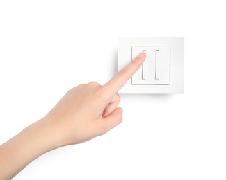 Woman pressing light switch on white background, closeup