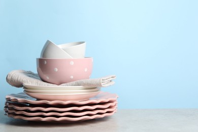 Photo of Beautiful ceramic dishware on light grey table, space for text