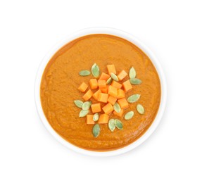 Delicious pumpkin cream soup with seeds in bowl isolated on white, top view