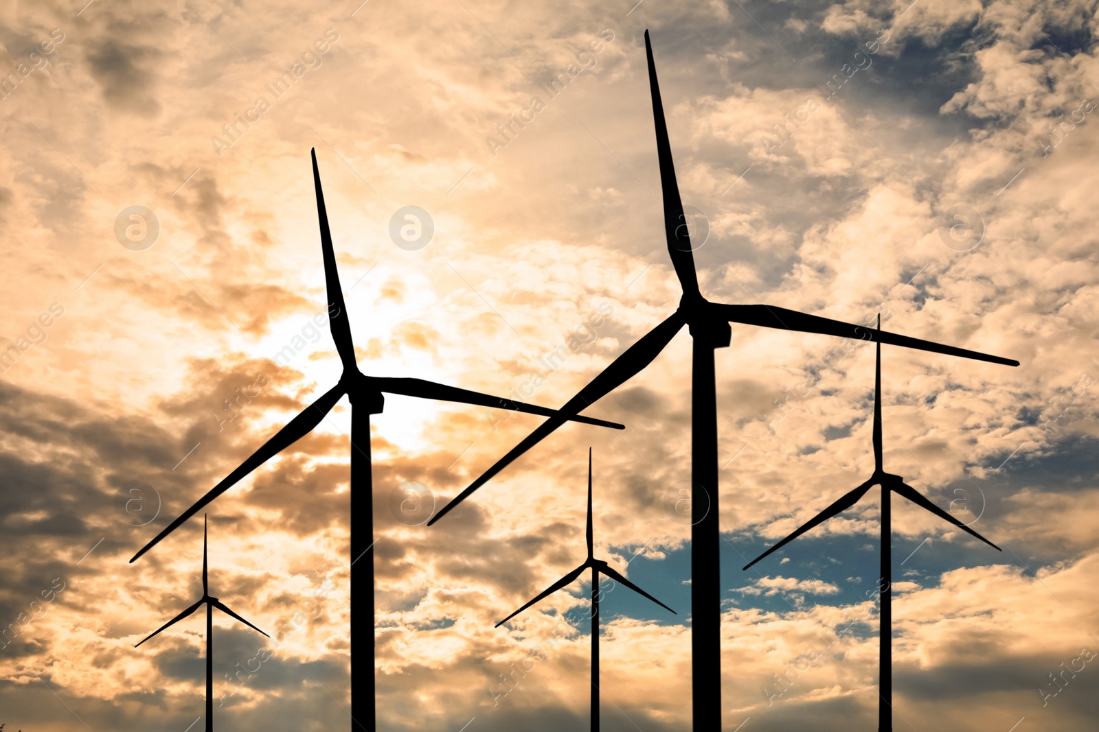 Image of Silhouettes of wind turbines at sunset. Alternative energy source