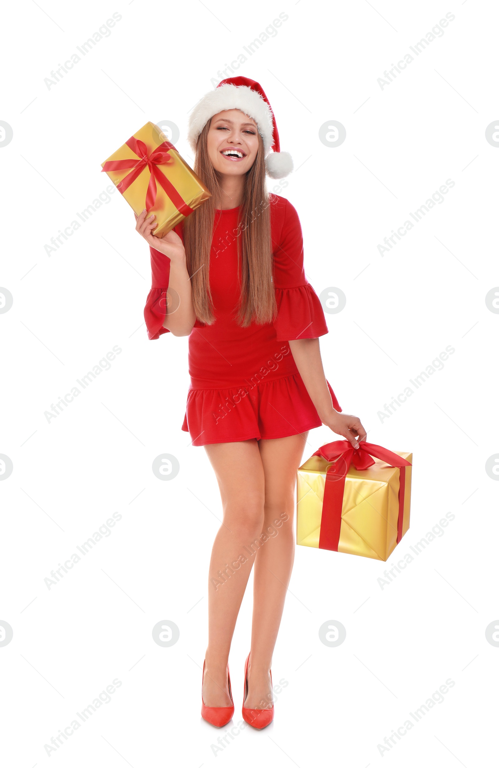 Photo of Happy young woman in Santa hat with Christmas gifts on white background