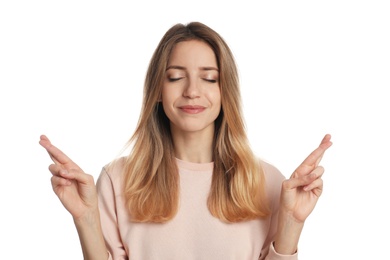 Woman with crossed fingers on white background. Superstition concept