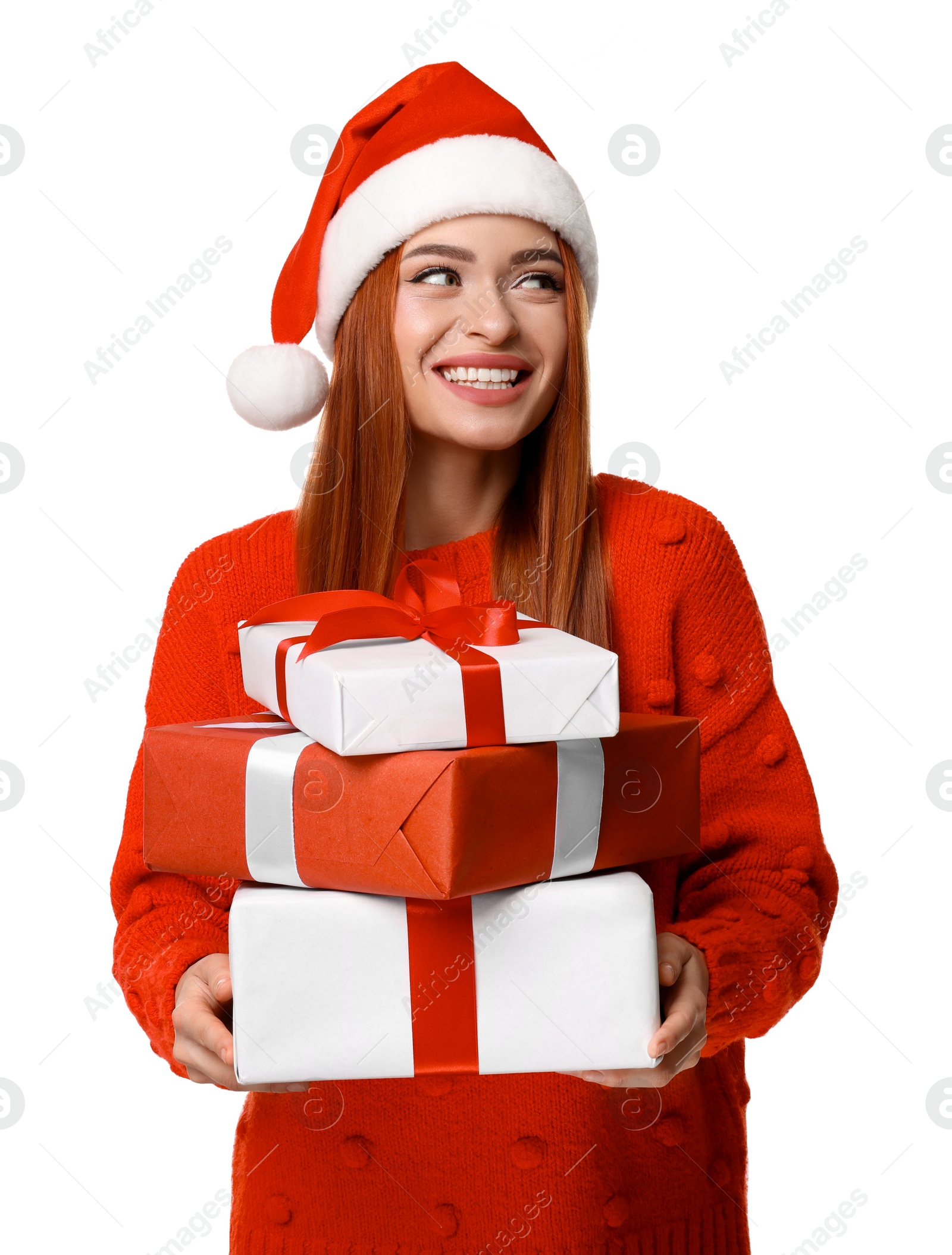 Photo of Young woman in red sweater and Santa hat with Christmas gifts on white background