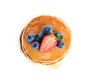 Stack of delicious pancakes with fresh berries and syrup on white background, top view