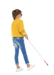 Photo of Blind girl with long cane walking on white background