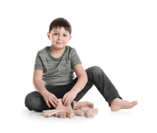Photo of Cute child playing with wooden blocks on white background