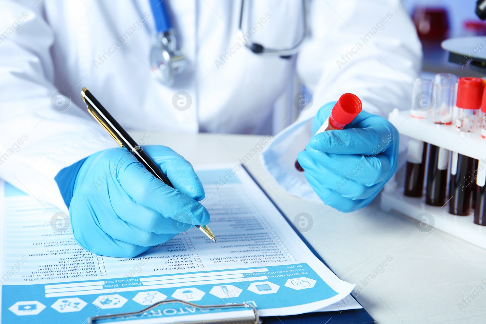 Photo of Scientist working at table in laboratory, closeup. Research and analysis