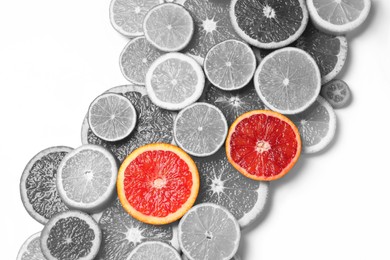 Image of Fresh citrus fruits on light background, flat lay. Black and white tone with selective color effect