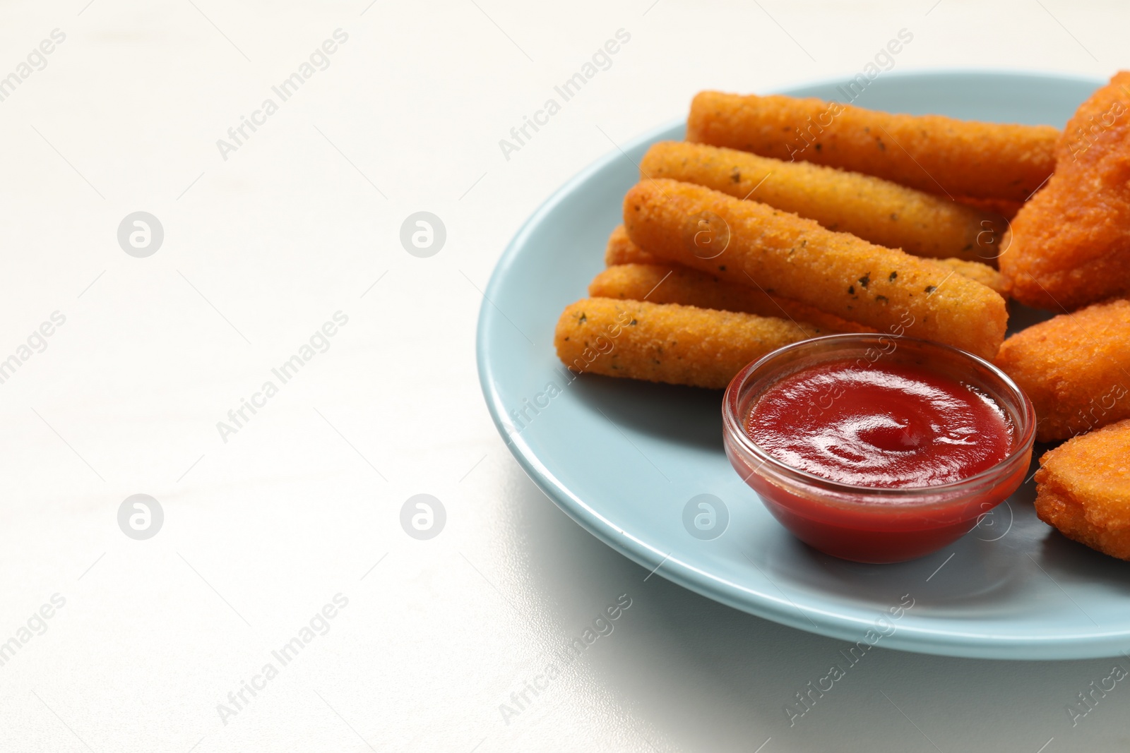 Photo of Plate with tasty ketchup and snacks on white table, closeup. Space for text