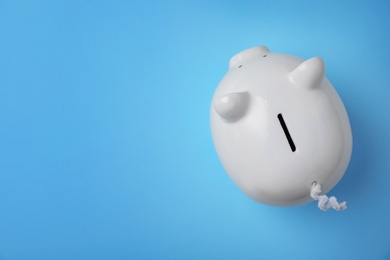 Photo of White piggy bank on color background, top view