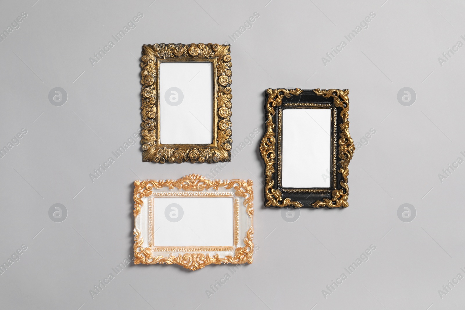 Photo of Empty vintage frames hanging on light gray wall