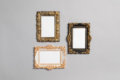 Photo of Empty vintage frames hanging on light gray wall