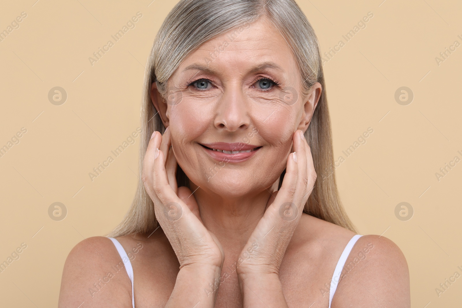 Photo of Portrait of beautiful senior woman on beige background