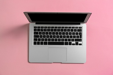 Photo of Modern laptop on color background, top view