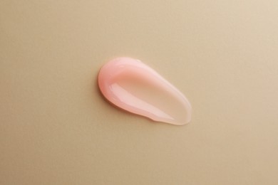 Photo of Sample of cosmetic gel on beige background, top view