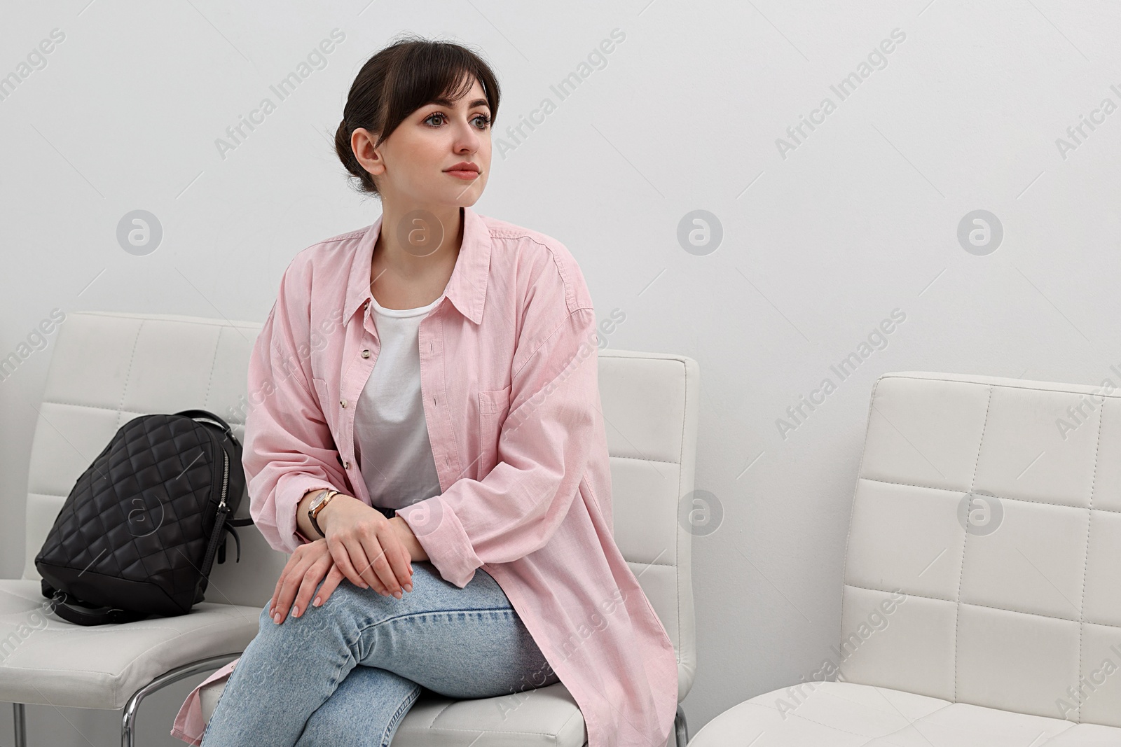 Photo of Woman sitting on chair and waiting for job interview indoors