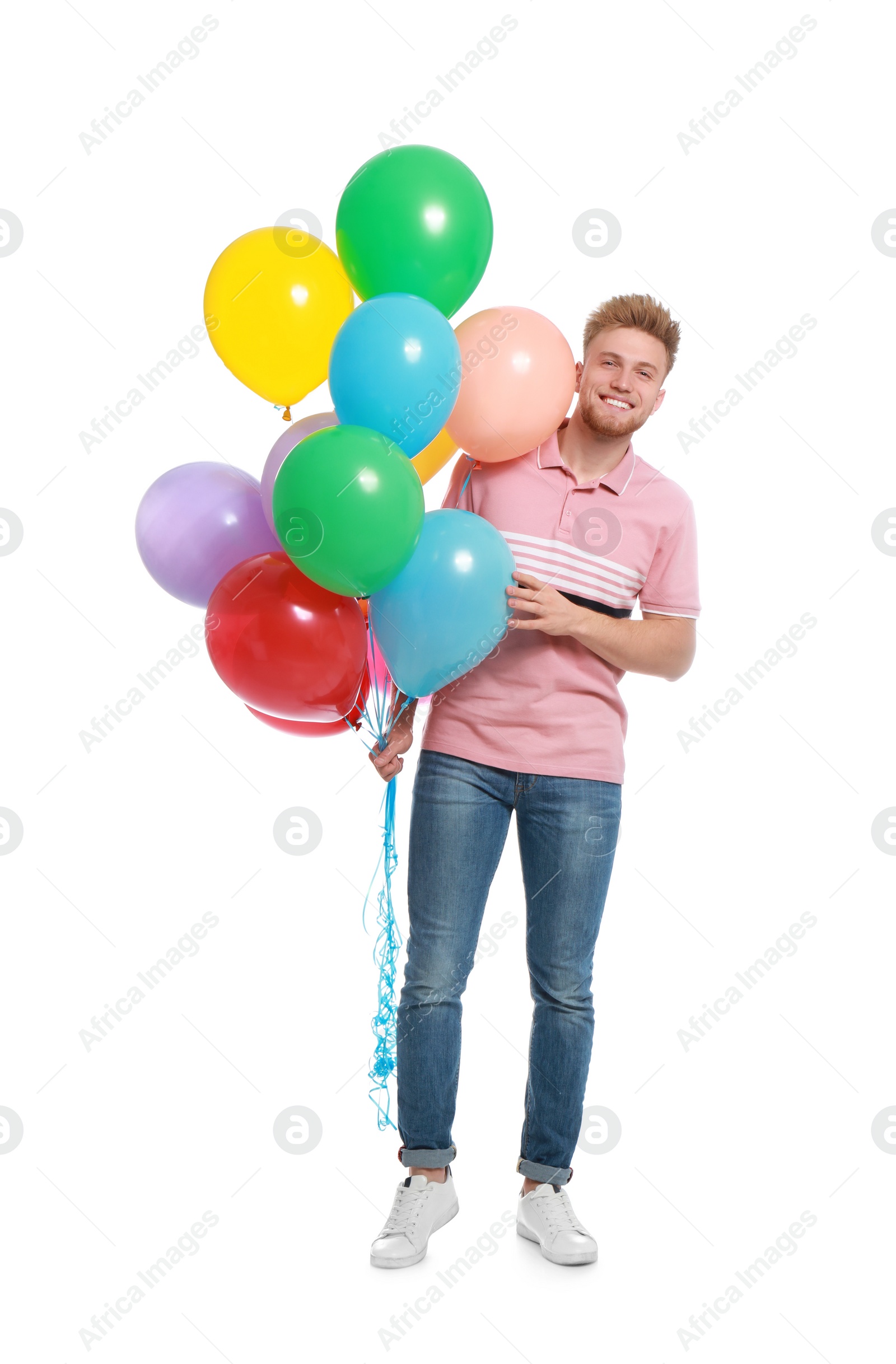 Photo of Young man holding bunch of colorful balloons on white background