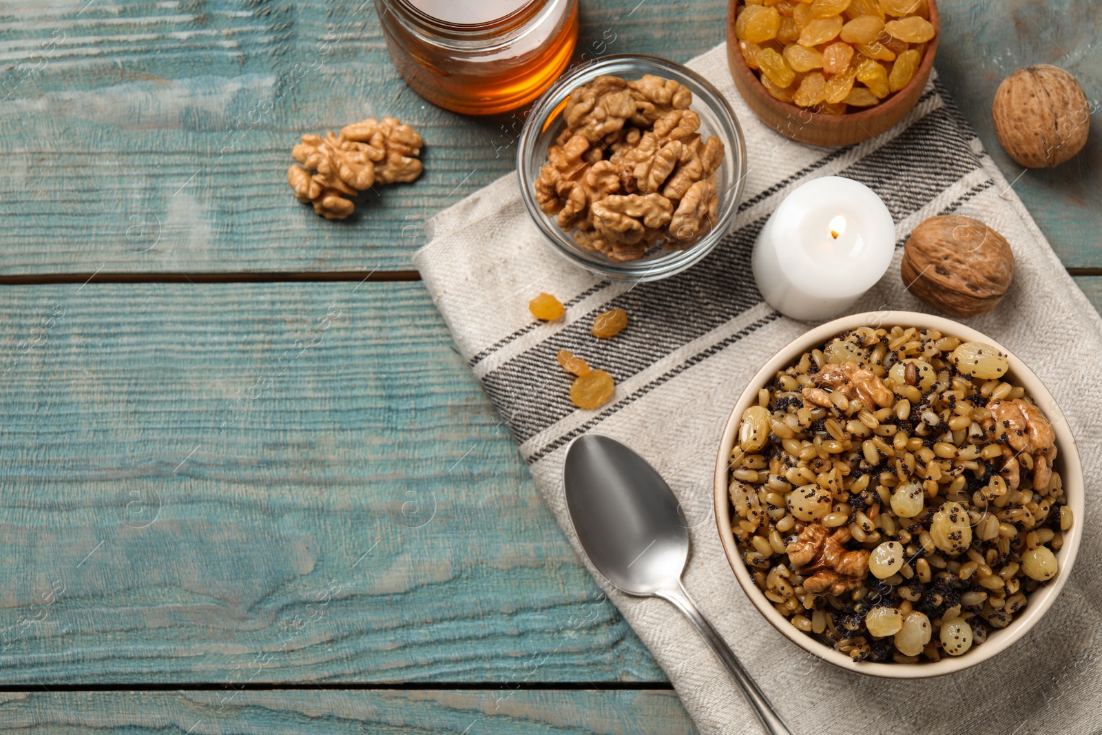 Photo of Traditional Christmas slavic dish kutia served on light blue wooden table, flat lay. Space for text