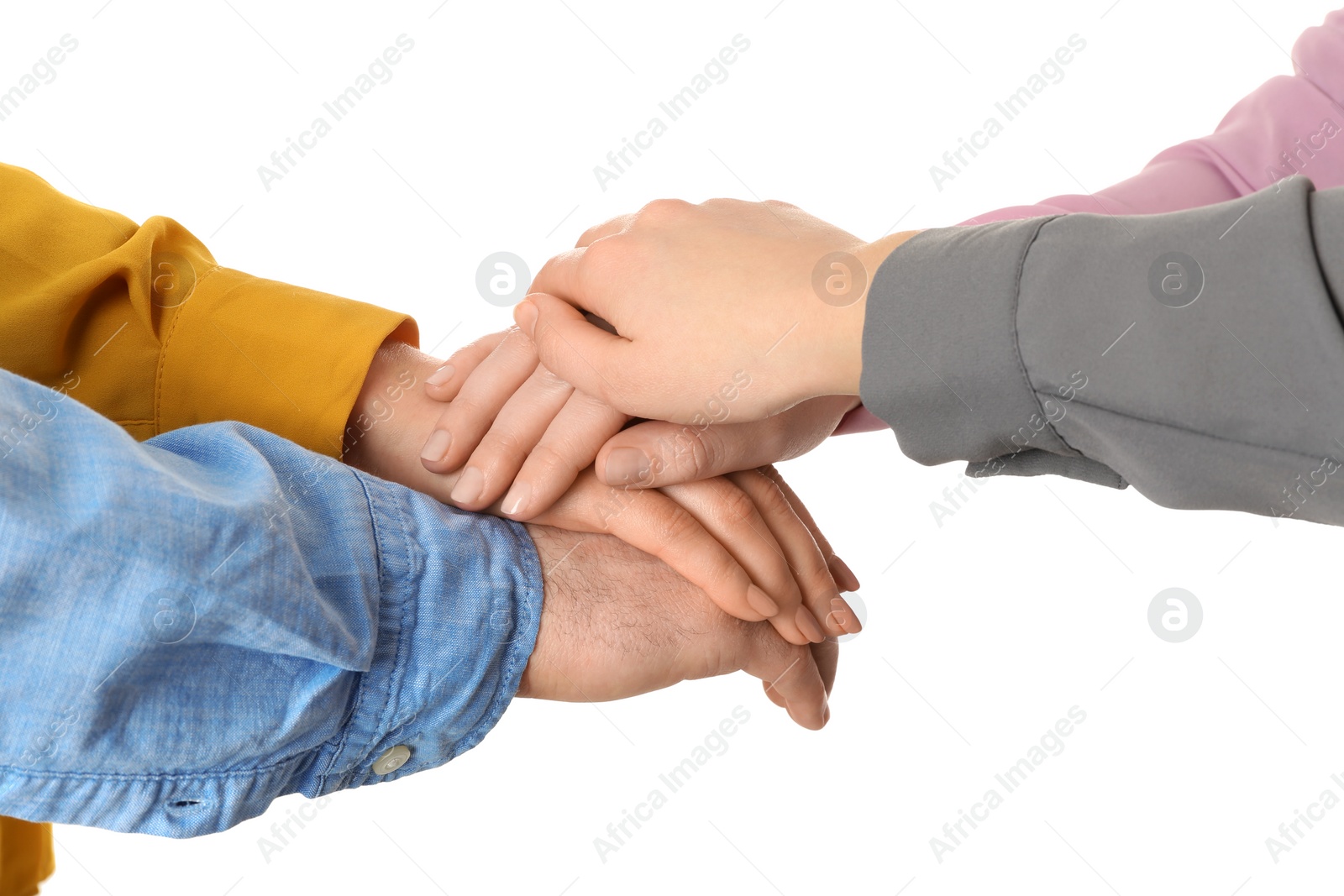 Photo of Young people putting their hands together on white background, closeup