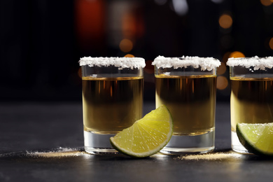 Mexican Tequila shots, lime slices and salt on bar counter