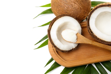 Photo of Spoon with coconut oil and nuts on white background