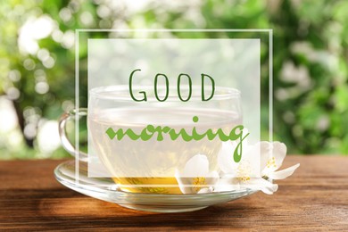 Good morning. Glass cup of aromatic jasmine tea and fresh flowers on wooden table