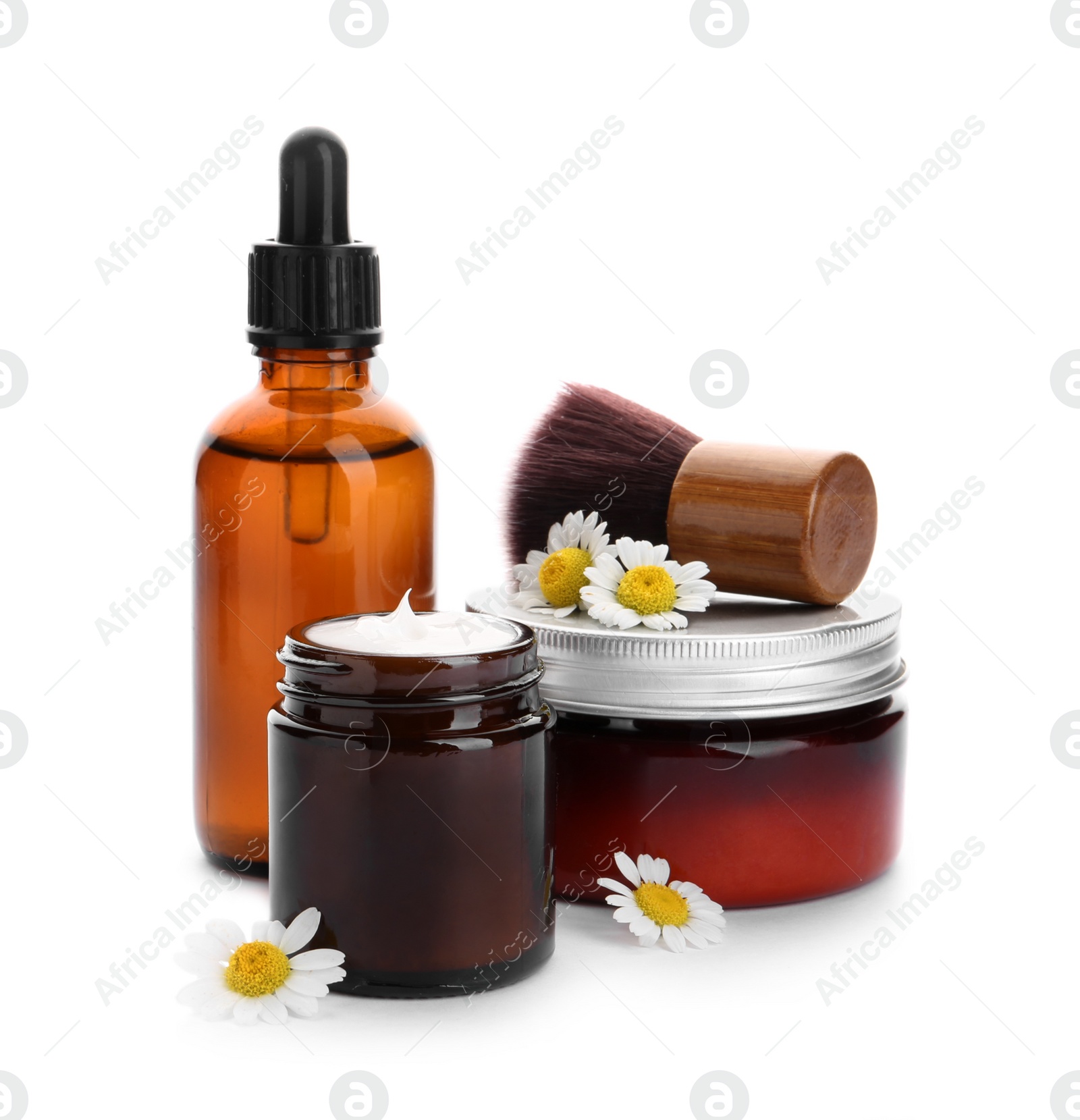 Photo of Set of different cosmetic products, brush and chamomile flowers on white background