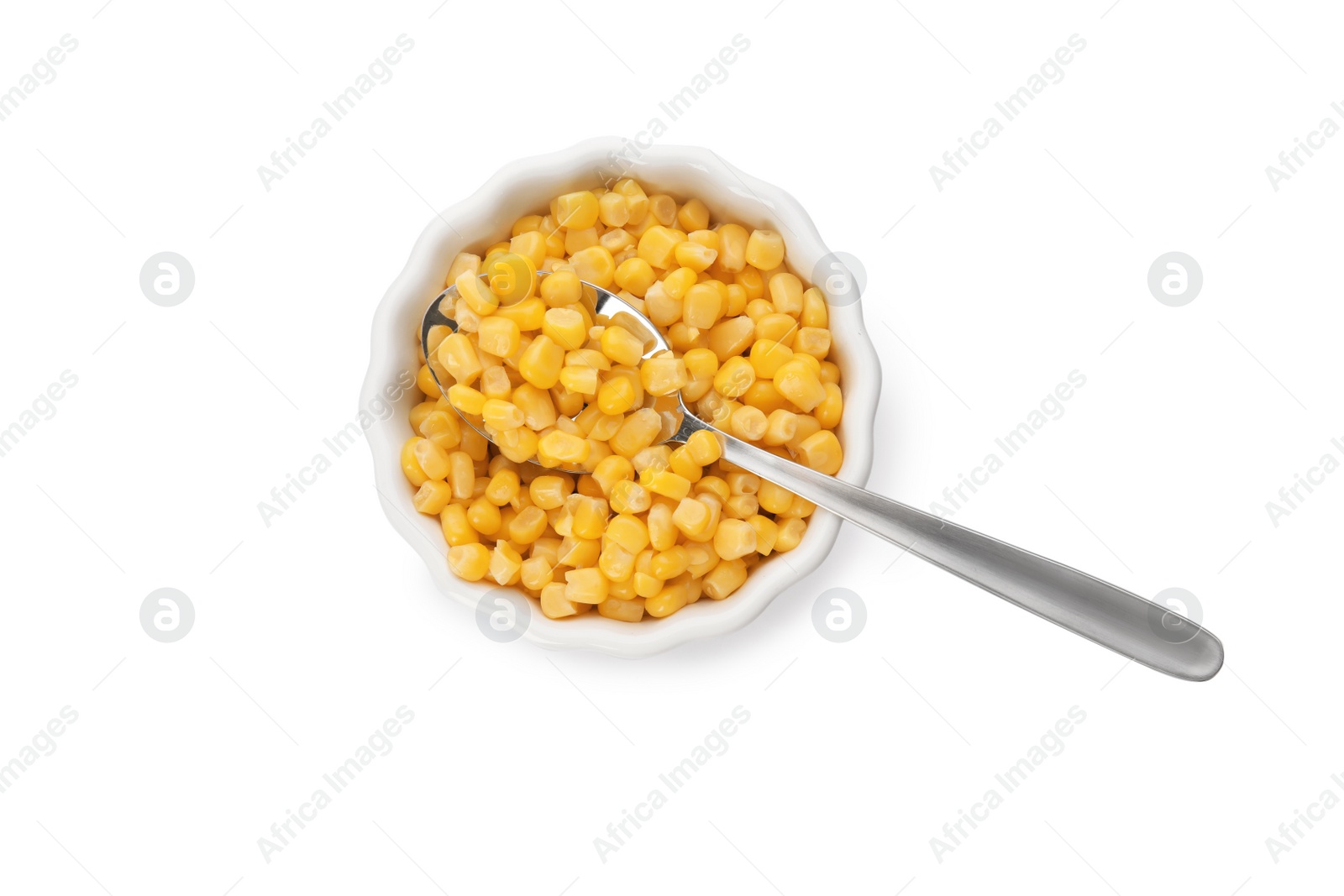 Photo of Bowl and spoon with corn kernels on white background, top view